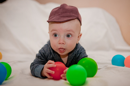 Happy child playing and having fun with colorful balls.の写真素材