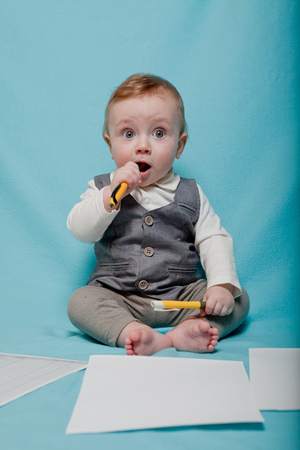 baby in office style, little boy grizzled pen on blue background.の写真素材