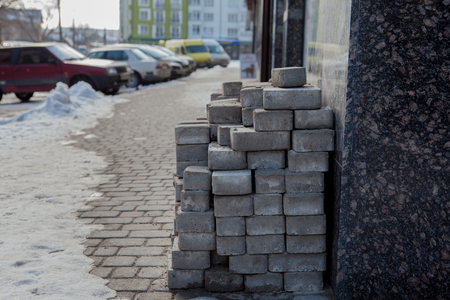 piled up bricks on a newly paved parking area.の写真素材