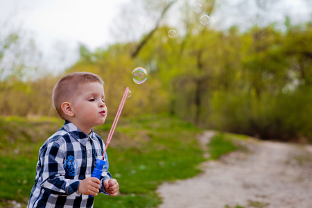 Little boy blowing soap bubbles, little boy blowing soap bubbles.の写真素材