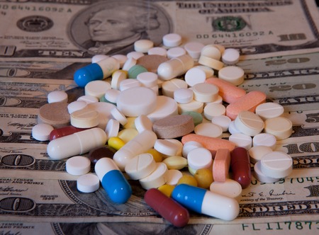 Medicine pills or capsules with money, dollar. Medical or pharmacy prescription for health. Business, finance concept. Cost of the healthy life.の写真素材