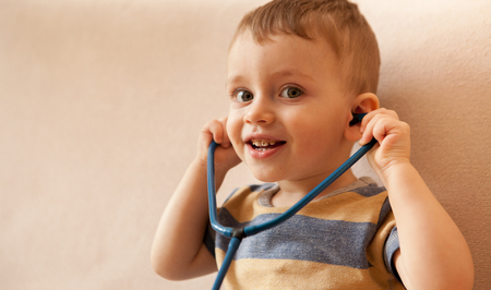 Little boy playing doctor with a stethoscope.の写真素材