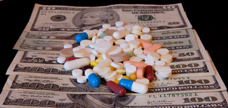 Medicine pills or capsules with money, dollar. Medical or pharmacy prescription for health. Business, finance concept. Cost of the healthy life.の写真素材