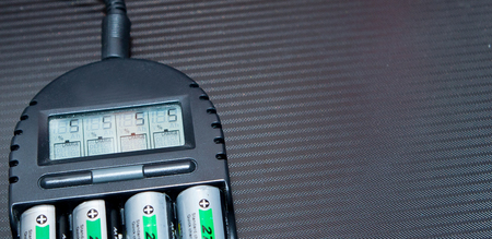 Close up of rechargeable lithium-ion battery with charger.の写真素材