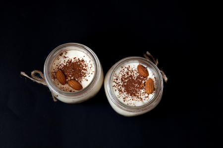 Delicious Dessert in a glass jar on a black background, top viewの写真素材