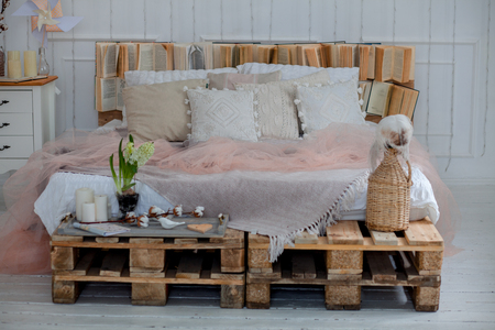 modern interior and home decor concept. with pillows and a blanket, candles. a big star of the lamps. deer on the pillows. wooden partsの写真素材
