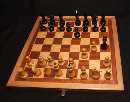 Abstract composition of chess figures. Isolated on black background, mat in two turns.の写真素材
