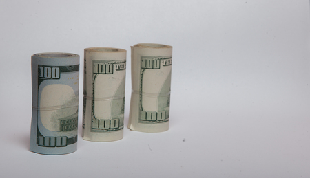 A roll of money, highlighted on a white background, a place for the text.の写真素材