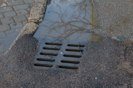 Rain water flows down the hatch cover on a sunny autumn day.の写真素材