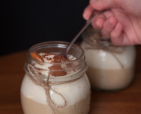 woman's hand taking delicious dessert by spoon.の写真素材