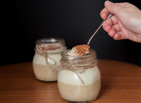 woman's hand taking delicious dessert by spoon.の写真素材