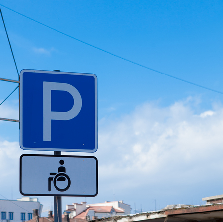 Parking sign for disabled people on a sky background.の写真素材