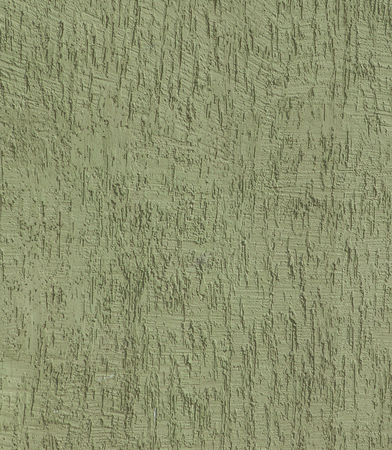 Fragment of the house wall covered with textured plaster. Textured green color handmade surface for background.の写真素材