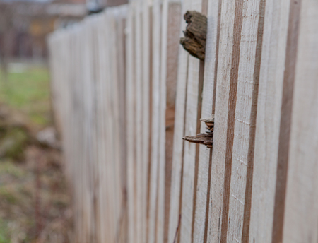 Wooden fence background. Stack of new wooden studs at the lumber yardの写真素材