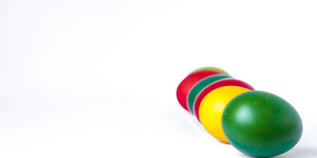 Colored easter eggs isolated on white background, place for text.の写真素材
