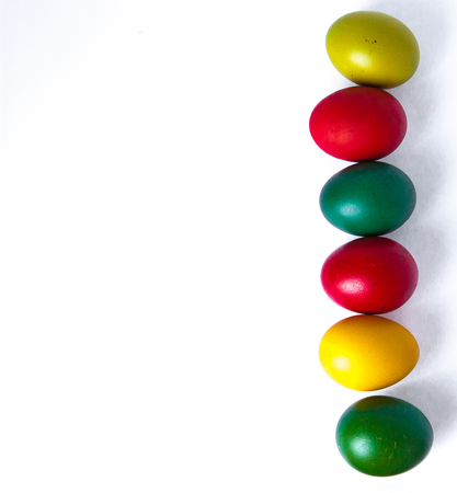 Colored easter eggs isolated on white background, place for text.の写真素材