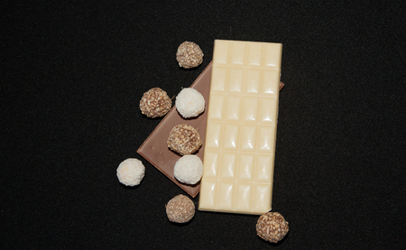 Stack of Black and White Chocolate isolated on black background, top view with copyspace for your text.の写真素材