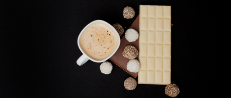 Cofe, Stack of Black and White Chocolate isolated on black background, place for text.の写真素材