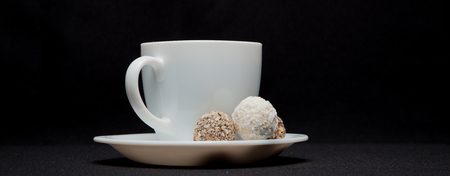 Coffee cup, beans, chocolate and macaroons on old kitchen table. Top view with copyspace for your text.の写真素材