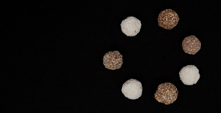 Stack of Black and White Chocolate isolated on black background, top view with copyspace for your text.の写真素材