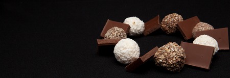Stack of Black and White Chocolate isolated on black background, top view with copyspace for your text.の写真素材