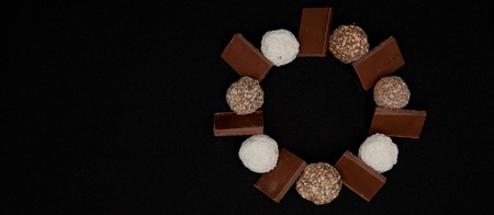 Stack of Black and White Chocolate isolated on black background, top view with copyspace for your text.の写真素材