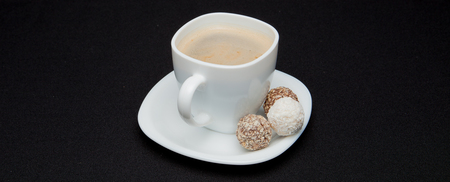 Coffee cup, beans, chocolate and macaroons on old kitchen table. Top view with copyspace for your text.の写真素材