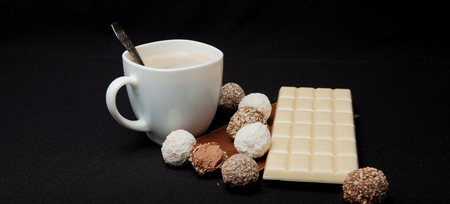 Cofe, Stack of Black and White Chocolate isolated on black background, place for text.の写真素材