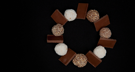 Stack of Black and White Chocolate isolated on black background, top view with copyspace for your text.の写真素材