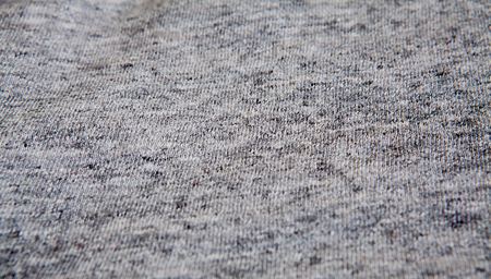 Real heather grey knitted fabric made of synthetic fibres textured backgroundの写真素材