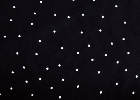 texture of silk fabric. background. white polka dots on a black background. Delicate black and white...