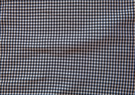Grey and white checkered fabric texture background.の写真素材