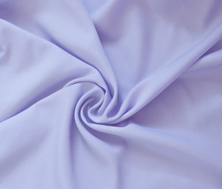 Closeup of rippled purple silk fabric, Beautiful and smooth silk background.の写真素材