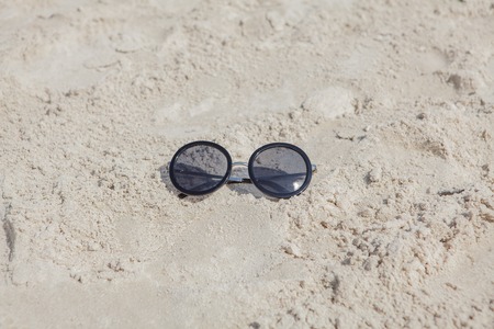 Reflecting sunglasses on the beach, glasses in the sand.の写真素材