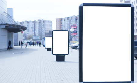 Advertising boards on the background of other billboards. Some billboards are not in focus. Copy space on a white background advertising boards.の写真素材
