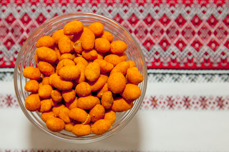 orange peanuts on a red cloth. top viewの写真素材
