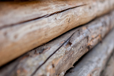 Folded wooden brown and gray planks in a sawmill. Piled alder boards as texture.の写真素材