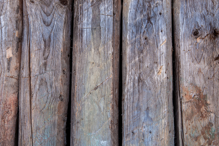 Magnificent background of a textured old wall made of grey wooden beams.の写真素材