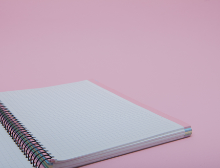 Notebook on pink background, lifestyle concept, top viewの写真素材
