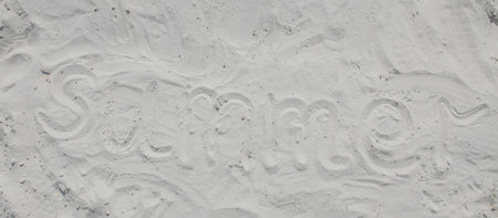 Summer written in the sand on the beach.の写真素材
