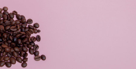 coffee beans on a pink background free space for the inscription on the right.