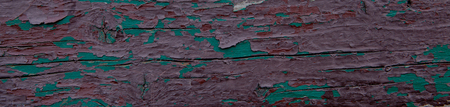 Old board with peeling paint of green and brown. Texture.の写真素材