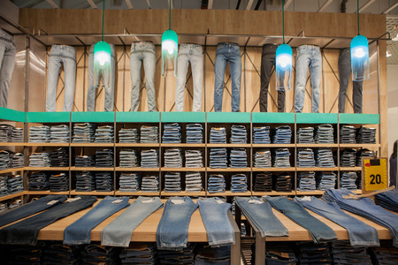 Jeans pants on the store shelf. Blue jeans denim Collection jeans stacked.の写真素材
