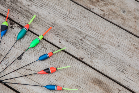 Fishing floats on a wooden background. Floats the fishing different on office table, cope space.の写真素材