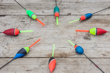 Fishing floats on a wooden background. Floats the fishing different on office table, cope space.の写真素材