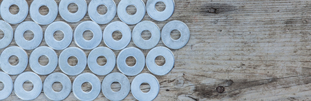 Background with washers. Washers and spring washers with an isolated old wooden background for commercial use are used.の写真素材