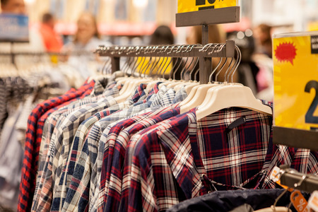 Clothes hang on a shelf . Cloth Hangers with Shirts. Men's stylish clothes.の写真素材