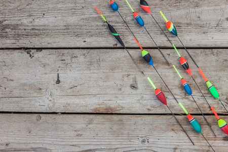 Fishing floats on a wooden background. Floats the fishing different on office table, cope space.の写真素材