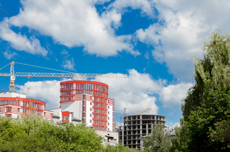 Construction site of a new apartment high building against blue sky. Residential area development....