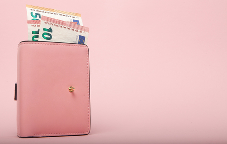 Wallet with Euro Currency on a Vibrant Blue Background.の写真素材